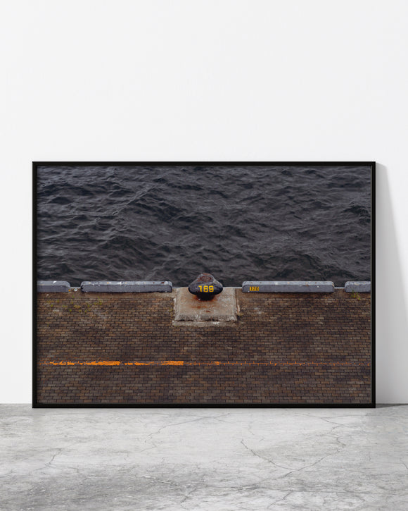 Urban waterfront print featuring dock number 169 against dark textured water – minimal and industrial aesthetic.