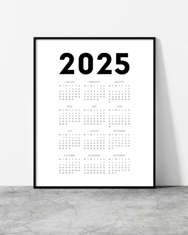 White 2025 wall calendar with bold black typography and a clean monthly overview.