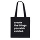 A black canvas tote bag designed by North Minimal featuring white letter text that reads "create the things you wish existed". The image shows the front of the tote bag with the text centered and clearly visible on the black background.