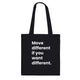 A black canvas tote bag designed by North Minimal featuring white letter text that reads "Move different if you want different.". The image shows the front of the tote bag with the text centered and clearly visible on the black background.