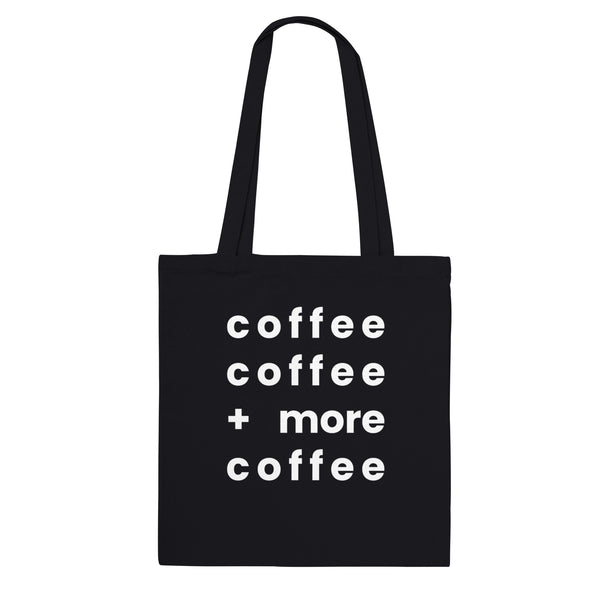 A black canvas tote bag designed by North Minimal featuring white letter text that reads "coffee coffee +more coffee". The image shows the front of the tote bag with the text centered and clearly visible on the black background.