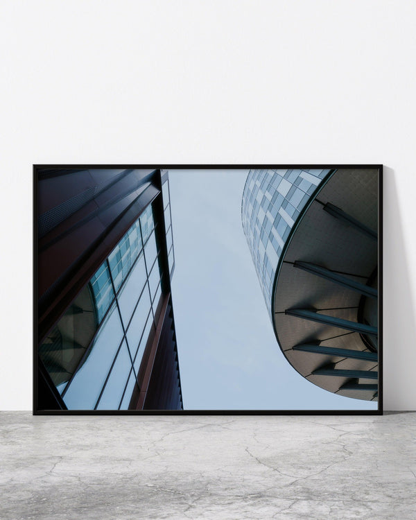 A modern architecture photo print in a black frame, displaying Copenhagen's contemporary architecture. The photograph captures the geometric shapes and clean lines of a unique building, showcasing its minimalist design.